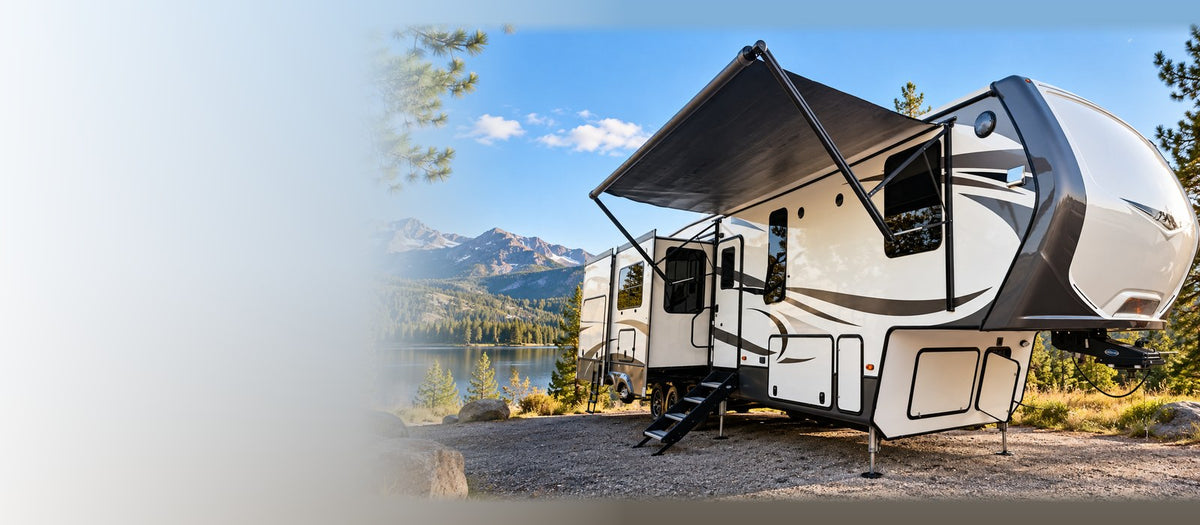 Fifth-wheel RV at a mountain lake campsite